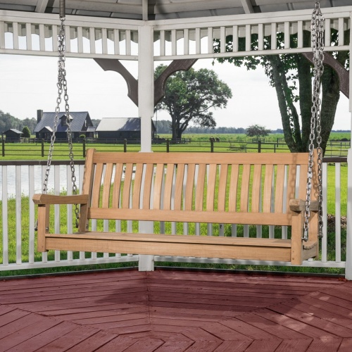 13955BO swinging veranda bench in gazebo overlooking grass and barn in background