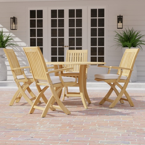 70043 Grand Hyatt Barbuda 5 pc Patio Dining Set of Grand Hyatt Dining Table and 4 Barbuda Folding Chairs on a brick paver patio with french doors and 2 potted ferns in background