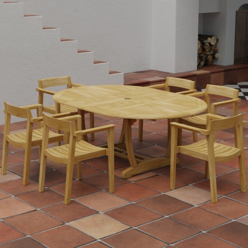 70364 Martinique Horizon teak 7 pc Dining Set of Martinique Dining Table and 6 Horizon Armchairs in angled side view on tiled terrace with staircase of house and firewood stack in background