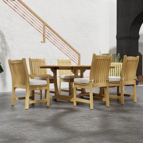 70369 Martinique Veranda Teak 7 pc Dining Set of Martinique Oval Table and 2 Veranda Arm Chairs and 4 Veranda Side Chairs side view on patio with stairs in background