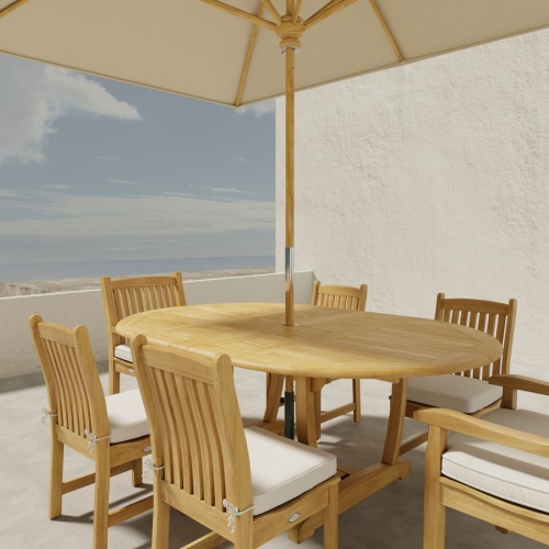 70379 Oval Veranda Chair Dining Set of Martinique Teak Oval Table and 2 Veranda Dining Arm Chairs and 4 Side Chairs with optional umbrella and cushions on outdoor terrace with ocean in the background