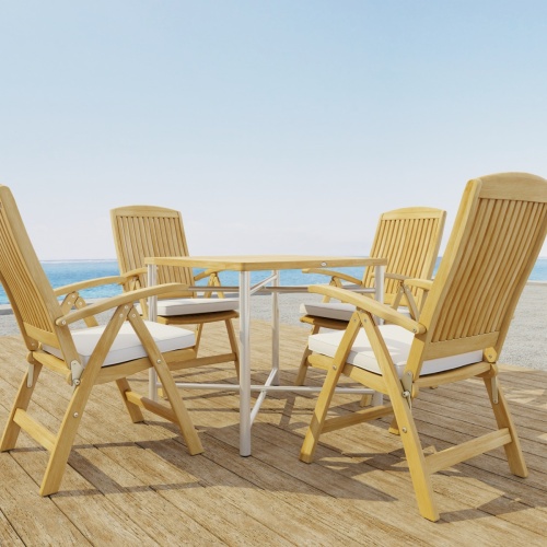 70381 Odyssey Recliner Foldable 5 pc Dining Set of Odyssey Table and 4 Barbuda Folding Chairs with optional seat cushions corner view on wood deck with ocean in background