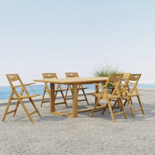  70382 Horizon Surf Dining Set for 6 of Horizon Rectangular Dining Table and 6 Surf Folding Dining Armchairs side angled view on stone patio with potted plant and the ocean in the background