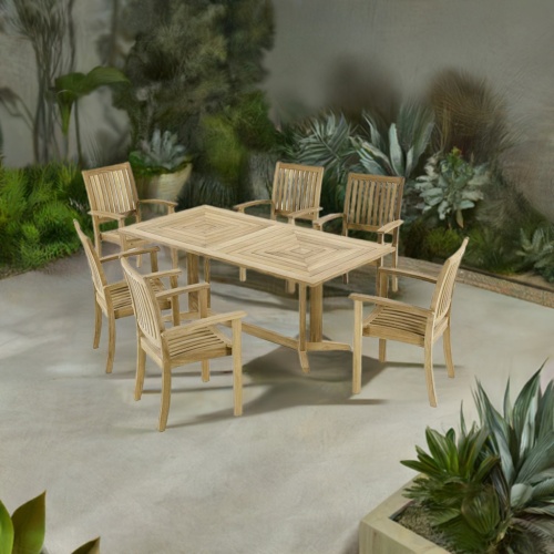 70517 Sussex Pyramid teak 7 pc Dining Set of Pyramid Rectangular Table and 6 Sussex Stacking Chairs angled aerial view on patio surrounded by landscaping plants in background