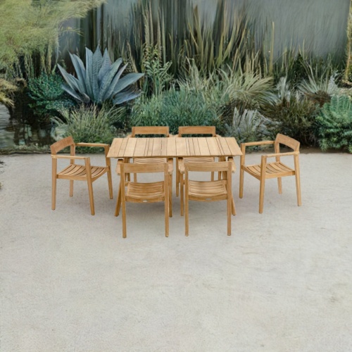 70524 Surf Horizon teak 7 pc rectangular Dining Set of Surf Teak Rectangular Table and 6 Horizon Dining Chairs angled side view on patio with privacy wall lined with succulent plants in the background