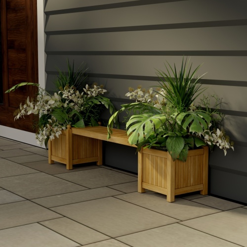 70530 Single Planter Bench Set of 2 planters filled with plants and 1 seat panel angled on stone patio against a wall and door in background