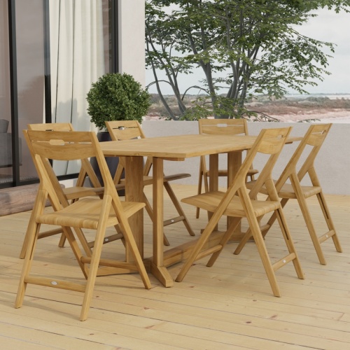 70538 Surf Pyramid Teak Dining Set for 6 angled end view on outdoor terrace in front of a glass door and potted with trees and ocean in background 