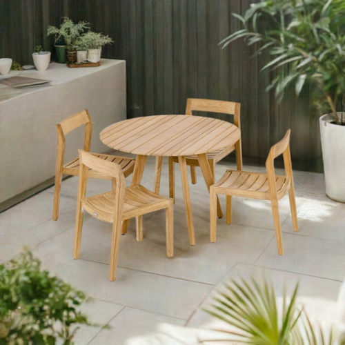 70546 Horizon Surf 5 pc Dining Set of Surf Teak 42 inch Round Dining Table and 4 Horizon Teak Chairs with privacy fence and potted plants in background