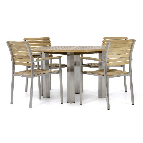 70625 Vogue Round Teak Dining Set of  4 Vogue teak and stainless steel dining Armchairs around a Vogue 48 inch Round Teak Table in side view on white background