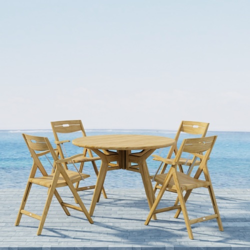 70804 Surf Marine Grade 42 inch round Folding Dining Set for 5 angled view on patio with ocean and blue sky in background