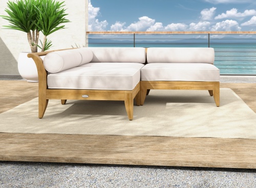 70822 aman dais sectional set on outdoor terrace next to a potted tree and blue sky and ocean view in the background