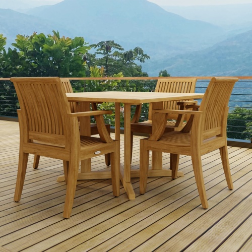 70904 Laguna Pyramid 5 pc Square Dining Set of Pyramid Square Table and 4 Laguna Armchairs side profile view on wood deck with trees and hillside and blue sky in the background 