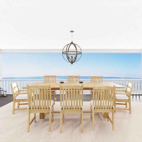 70925 Horizon Veranda teak rectangular dining set of Horizon rectangular table and 6 Veranda Side Chairs and 2 Armchairs with optional cushions angled on covered patio with ocean in background