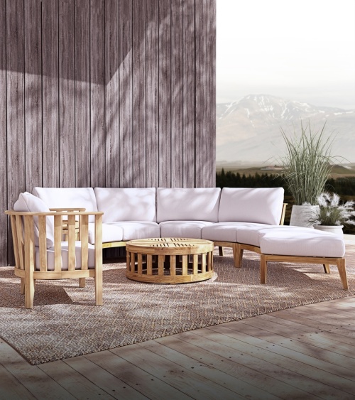 70929 Kafelonia 6 piece Sofa Sectional Set angled front view on outdoor patio in front of building next to 2 potted plants with mountains in backgrond