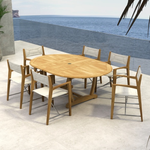 70366 Oval Odyssey Chair 7 pc Dining Set of Martinique Oval Table and 6 Odyssey Director Chairs on outdoor terrace with potted tree and ocean background