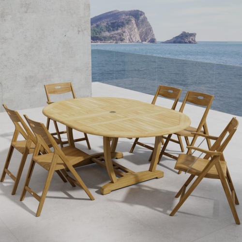 70371 Oval Surf Chair 7pc Dining Set of Martinique Oval Table and 2 Surf Armchairs and 4 Side Chairs angled end view on outdoor terrace with ocean and mountain in background