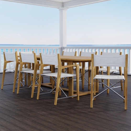 70366 Oval Odyssey Chair 7 pc Dining Set of Martinique Oval Table and 6 Odyssey Director Chairs on outdoor terrace with potted tree and ocean background