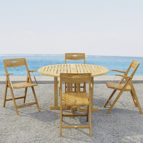 70376  Surf Barbuda 5 pc Folding Dining Set of 4 Surf folding Dining Chairs and a Barbuda 48 inch Round Table on outdoor terrace with the ocean in the background