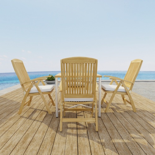 70381 Odyssey Recliner Foldable 5 pc Dining Set of Odyssey Table and 4 Barbuda Folding Chairs optional seat cushions side view on wood deck with ocean in background