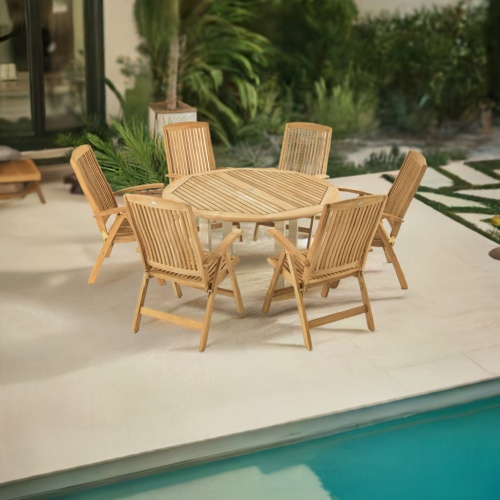 70480 Vogue Reclining Dining Set for 6 on a pool deck angled aerial view next to a pool and windows with landscaping trees and shrubs in the background