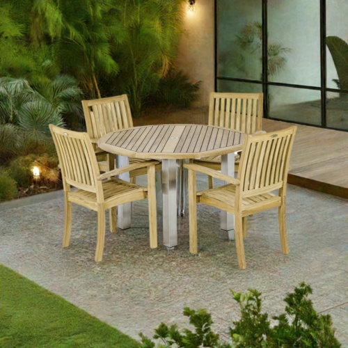 70624 Vogue Sussex Dining Set of the Vogue 48 inch Round Dining Table and 4 Sussex Stacking Chairs on patio in front of glass doors and trees in the background