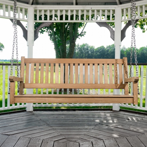 13955bo swinging veranda teak bench in gazebo overlooking grass and barn in background