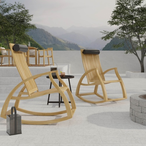 16419DP Aria Rocker with neck roll  showing 2 Aria Rockers angled side view on stone patio next to firepit with terrace wall and mountains in background