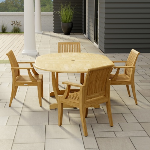 70305 Martinique 5 piece Dining Set angled end view on stone patio with 2 pillars of house with a plant and trees and privacy wall in the background  