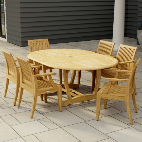 70306 Martinique 7 pc Teak Dining Set of Martinique Teak Oval Extending Dining Table and 6 Laguna DIning Chairs end angled on stone patio with a house in the background