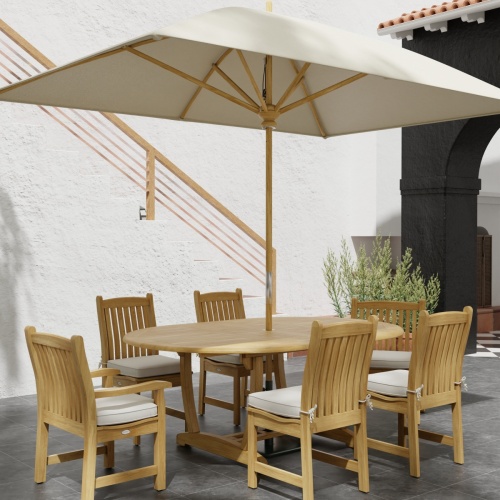 70369 Martinique Veranda Teak 7 pc Dining Set  with optional open rectangular umbrella angled side view on patio with stairs and plant in background  