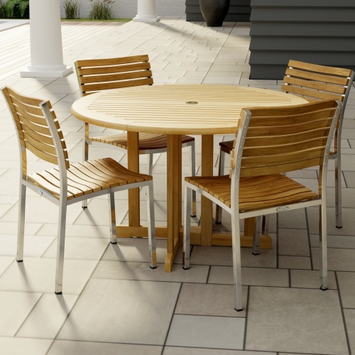 70735 Barbuda Vogue 5 pc Teak DIning Set of Barbuda 48 inch Round Dining Table and 4 Vogue Teak and 304 Stainless Steel Side Chairs on tiled patio with partial columns and house in the background