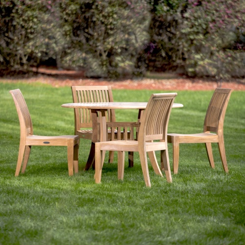 70291 5 piece Hyatt Laguna 5 piece Teak Dining Set on grass field with trees in background