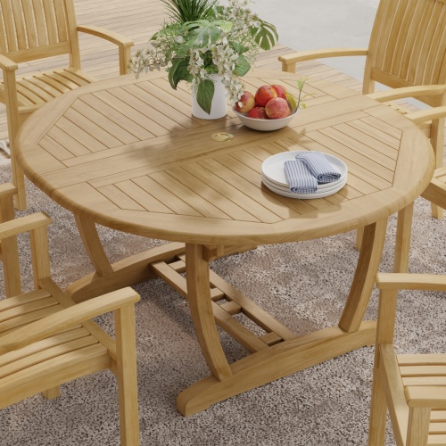 15548 Martinique Teak Extension Table in angled top view collapsed position on patio with plate and flower vase on table and 4 chairs in background