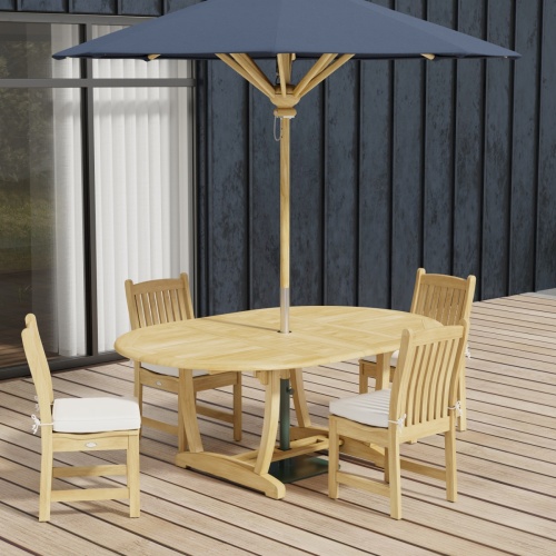 70031 Martinique Veranda 5 pc Dining Set of Martinique Oval Teak Table and 4 Veranda Side Chairs with optional round umbrella on wood deck with glass door and building in background