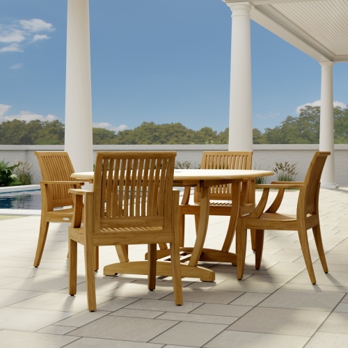 70305 Martinique 5 piece Dining Set  angled end view on stone patio with 3 pillars and pool and trees and privacy wall in the background  