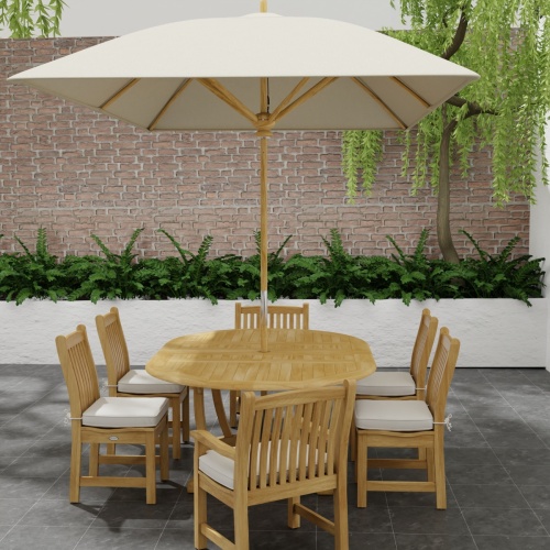 70369 Martinique Veranda Teak 7 pc Dining Set  with optional open rectangular umbrella angled end view on patio with plants and brick wall in background 