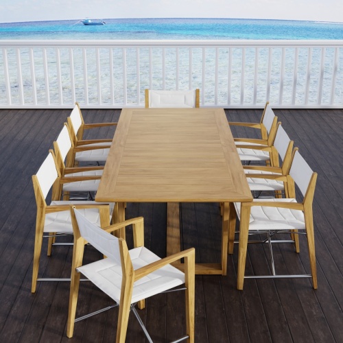 70366 Oval Odyssey Chair 7 pc Dining Set on outdoor terrace showing closeup view of 2 chairs and partial view of table with ocean background 