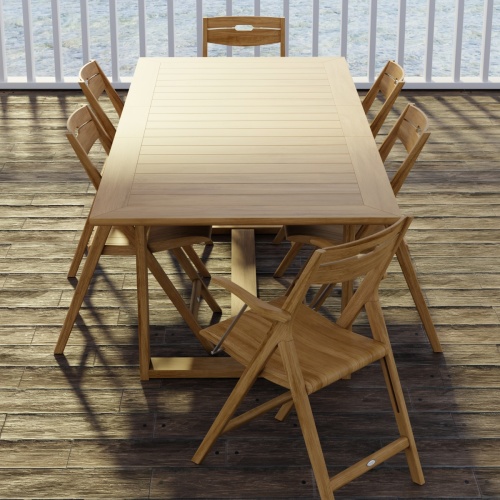 70378 Horizon Surf 7 pc Dining Set of Horizon Dining Table and 2 Surf Folding Dining Armchairs and 4 Side Chairs on wood patio with white deck railings and the ocean in the background