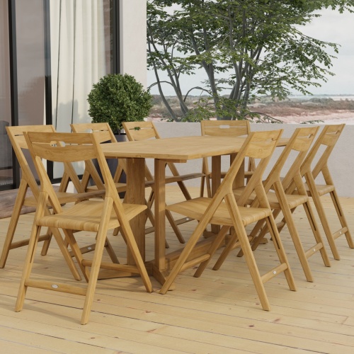 70464 Surf Pyramid Teak Dining Set for 8 angled end view on outdoor terrace in front of a glass door and potted with trees and ocean in background 