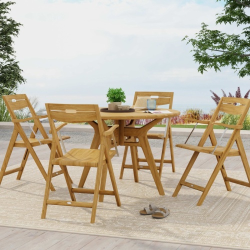 70804 Surf Marine Grade 42 inch round Folding Dining Set for 5 with potted plant on wood tray and drinking glass on table top with trees and landscape plants in background