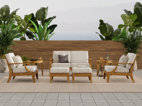 70877 Laguna 7 piece teak Love Seat Set on patio with privacy wall and tropical trees in background