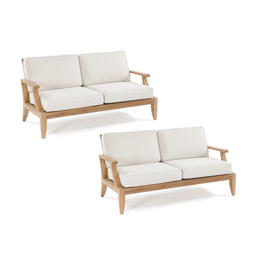 70914 two laguna teak loveseats with cushions angled on white background