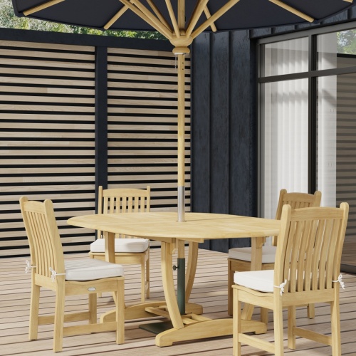 70031 Martinique Veranda 5 pc Dining Set of Martinique Oval Teak Table and 4 Veranda Side Chairs with optional round umbrella on wood deck with glass door and wall in background 