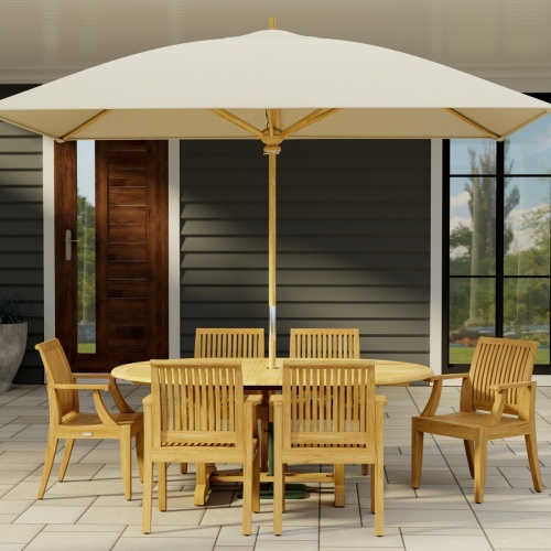 70306 Martinique 7 pc Teak Dining Set with optional rectangular umbrella in side view on stone patio with a house and door and window in the background