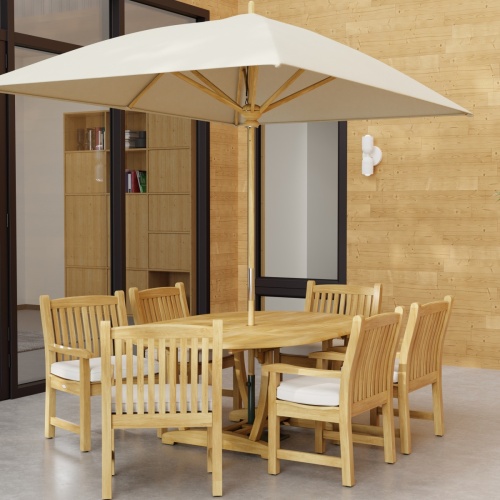 70374 Oval Veranda Chair Dining Set of Martinique Teak Oval Table and 6 Veranda Dining Chairs angled end view with optional rectangular umbrella on outdoor terrace a glass door and window in background