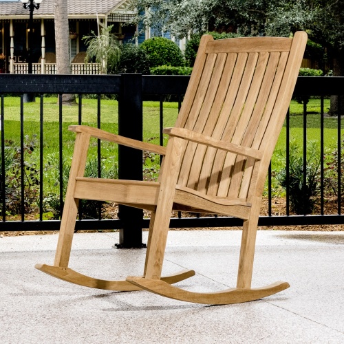 12223 veranda teak rocking chair on porch side view with railing and landscaped lawn in background