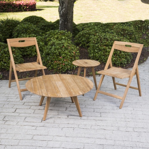 14917 Surf Teak Coffee Table on concrete pato with two surf chairs and one side surf table with bushes in background