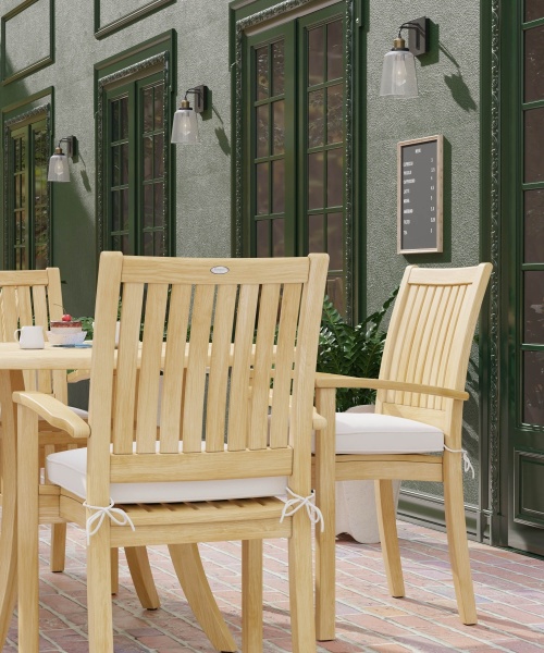 70027 Grand Hyatt 5 pc Dining Set on brick patio showing closeup side view of 2 dining chairs with optional seat cushions outdoors with glass doors in background