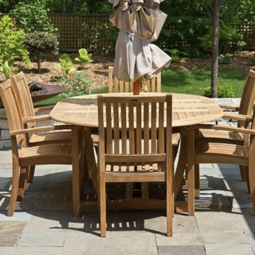 70214 Martinique Sussex  Teak 7 piece Dining Set on tiled patio showing optional closed umbrella in center of table end view with grass and trees in background