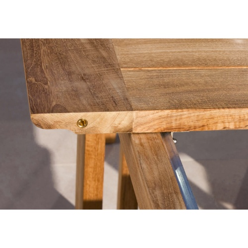 70299 Horizon teak dining table showing closeup view of table expanding mechanism on concrete terrace